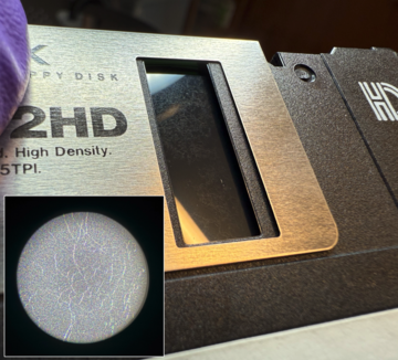 Photo of mold on a disk, with an inset image of what that mold looks like zoomed in with a pocket microscope, where viewers can see the webby-looking hyphae.