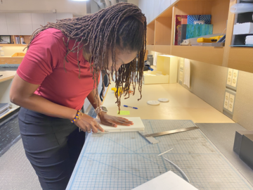 A woman working on a custom enclosure. 