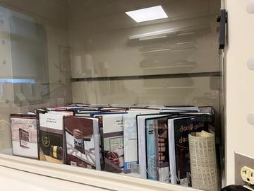 Books airing out inside a fume hood.