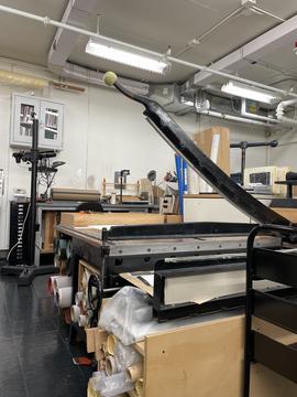 A conservation lab with a board shear in the foreground.
