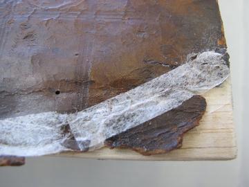 A new wooden piece filling in the missing board corner.