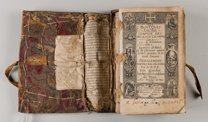 Book with front cover open to show the loose cover attachment. 