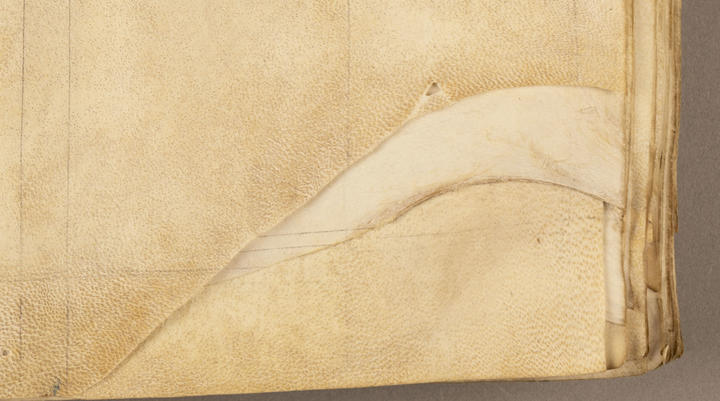 A close up of the uneven edges of a manuscript.