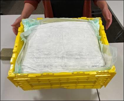 A rain catcher covering the top of a full book bin.