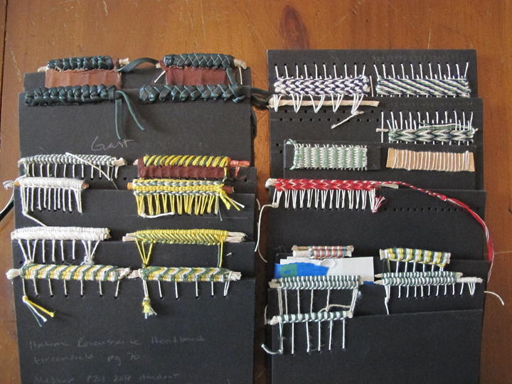 A collection of endband samples on cards made with a variety of colored threads.