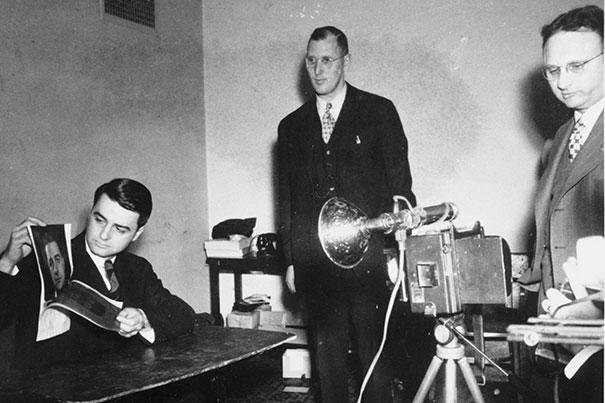 Three men with polaroid camera equipment.