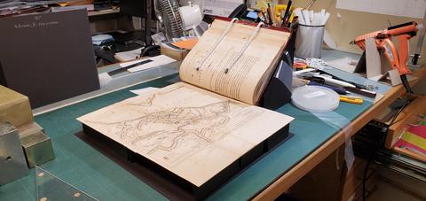 A folded out map on a custom support mount. 